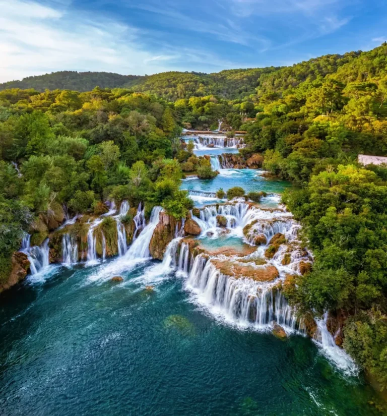 krka croatia aerial view of the beautiful krka waterfalls in krka national park on a bright summer morning with green foliage turquoise water and blue sky